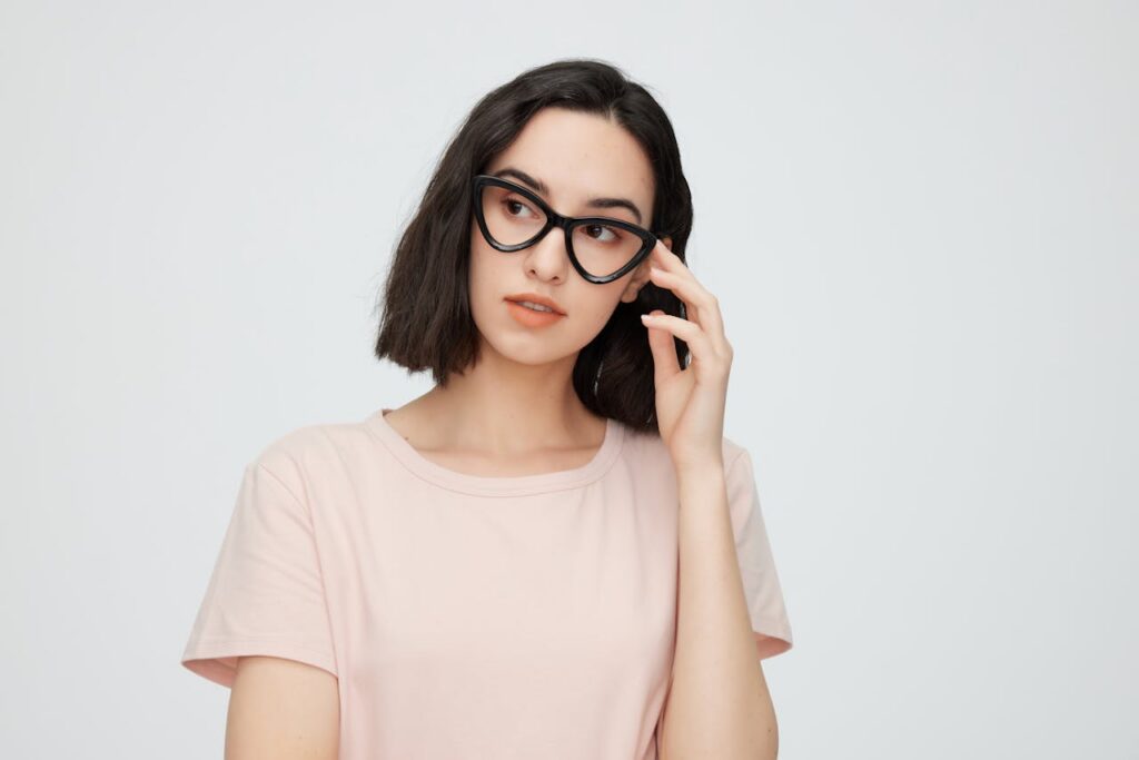 pexels-photo-27765567 Portrait of a fashionable young woman in eyeglasses, exuding elegance and intelligence.