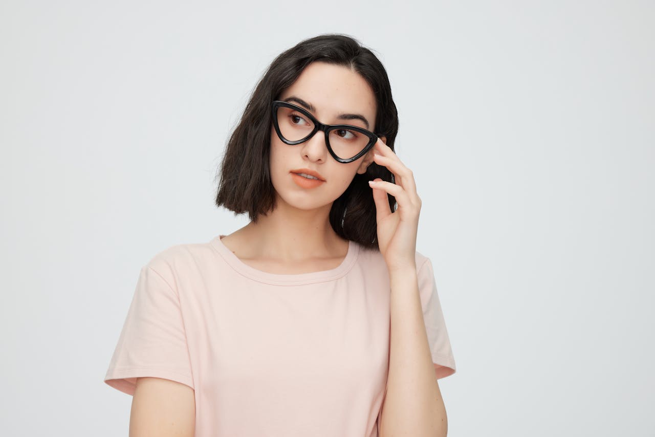 Portrait of a fashionable young woman in eyeglasses, exuding elegance and intelligence.